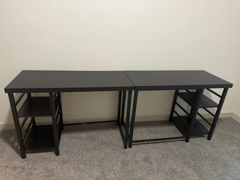 Long two-person desk assembled against a wall