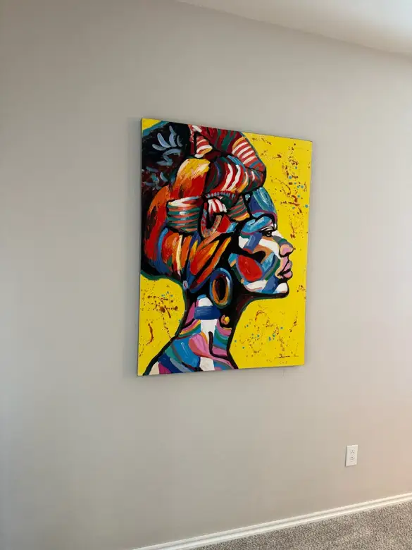 Framed canvas artwork hung level on a living room wall