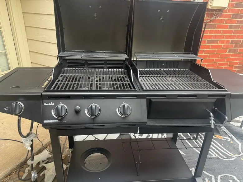 Four burner gas grill assembled on a back patio