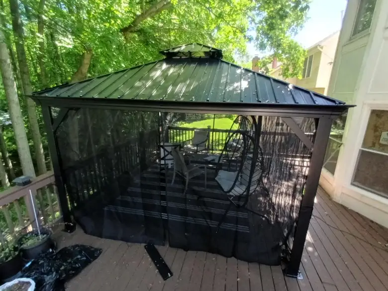 Screened gazebo assembled on a raised wooden deck