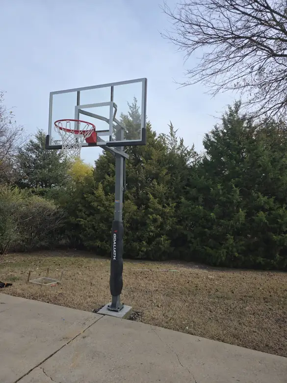 In-ground basketball hoop installed at the edge of a driveway