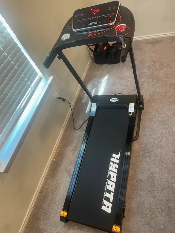 Treadmill assembled and set up in a spare room